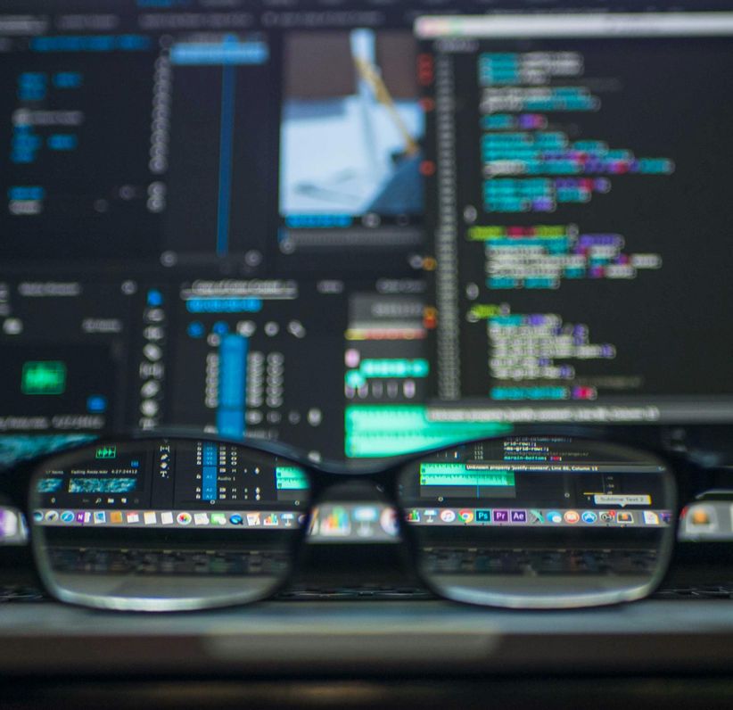 image of blurry code with glasses in front that make it clear