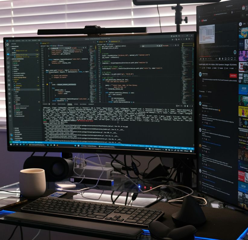 mage of two computer monitors showing code. the one of the right is vertical.