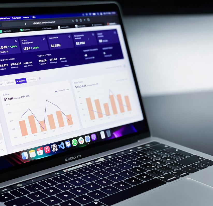 Image of a laptop showing an admin dashboard with some graphs and numbers